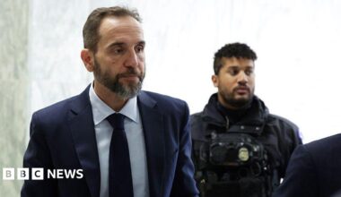 Former Special Counsel Jack Smith (left) arrives on Capitol Hill to testify about his criminal investigations of Donald Trump. He wears a navy blue suit.