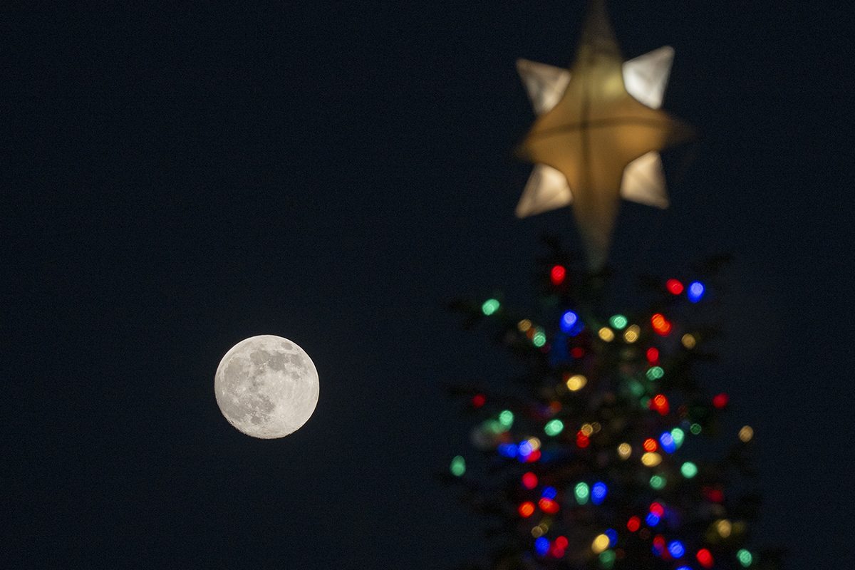 The December Cold Moon rises above the US Capitol Christmas Tree in Washington DC, United States on 3 December 2025. Photo by Celal Gunes/Anadolu via Getty Images