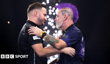 Arno Merk and Peter Wright embrace