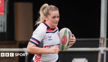Eboni Partington, playing for England, with the ball under her left arm