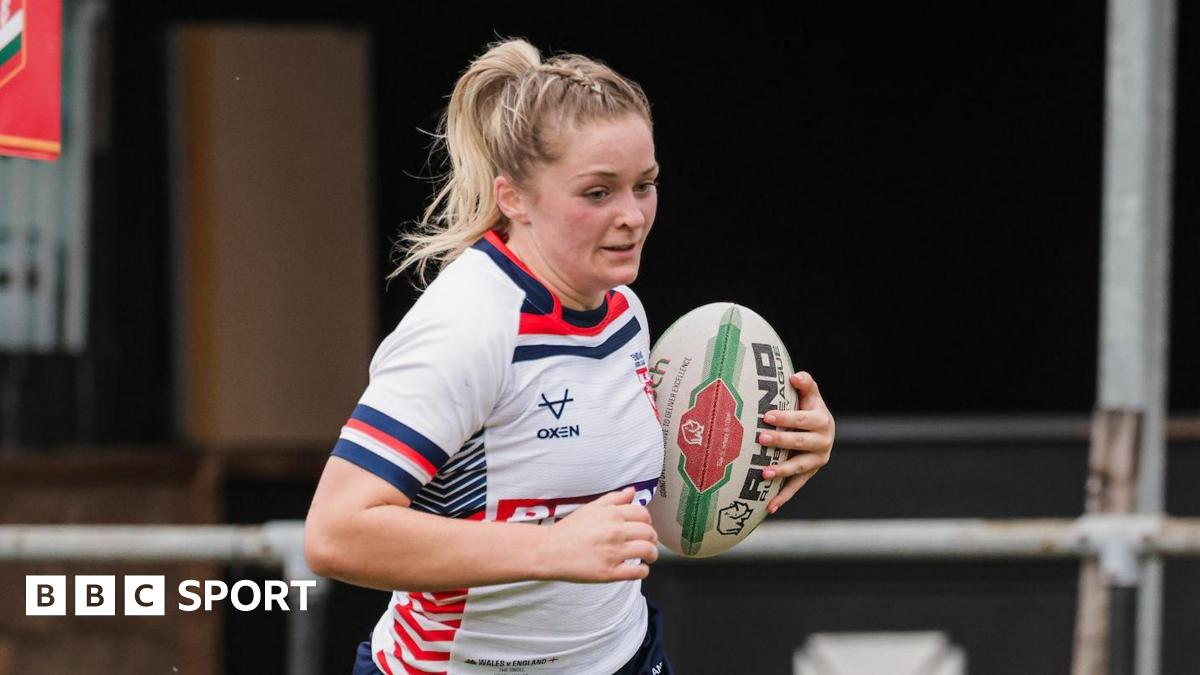 Eboni Partington, playing for England, with the ball under her left arm