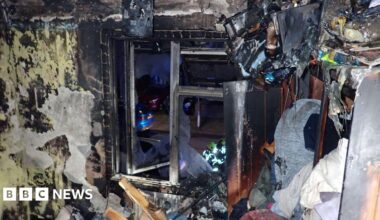 Room devastated by fire showing debris and what looks like a window.