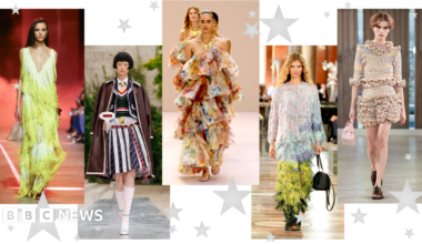 Five pictures of models walking down the catwalk. The first is in a fringed green dress with low v-neck; the second wears a striped pleated midi skirt, shirt and tie, tank top and blazer with brown leather coat draped over her shoulders; the third wears an off-shoulder, ruffled multicolour dress; the fourth wears a head-to-toe tasseled outfit with ombre blue and green effect; the fifth wears a ruffled mulitcolour mini skirt with ruffled three-quarter length sleeve top