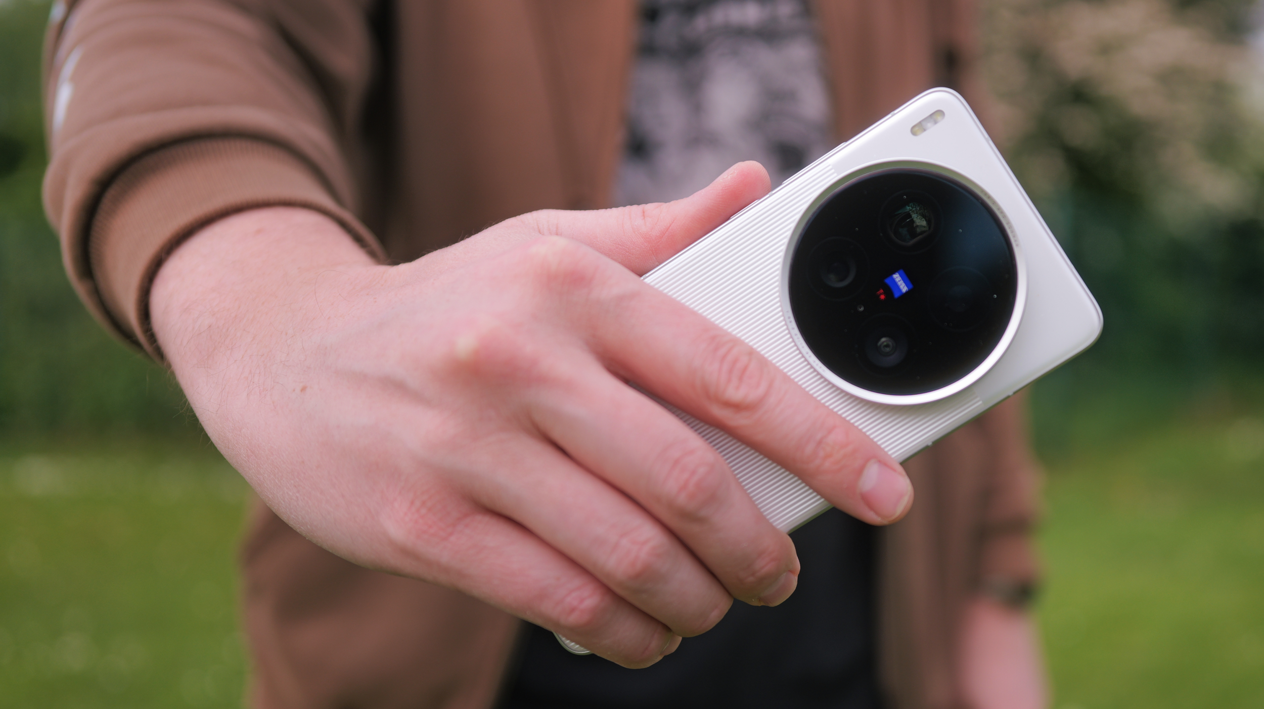 Vivo X200 Ultra phone held in a pair of hands outside
