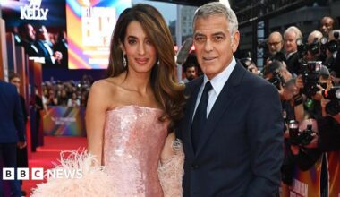 George and Amal Clooney on the red carpet at a movie premiere