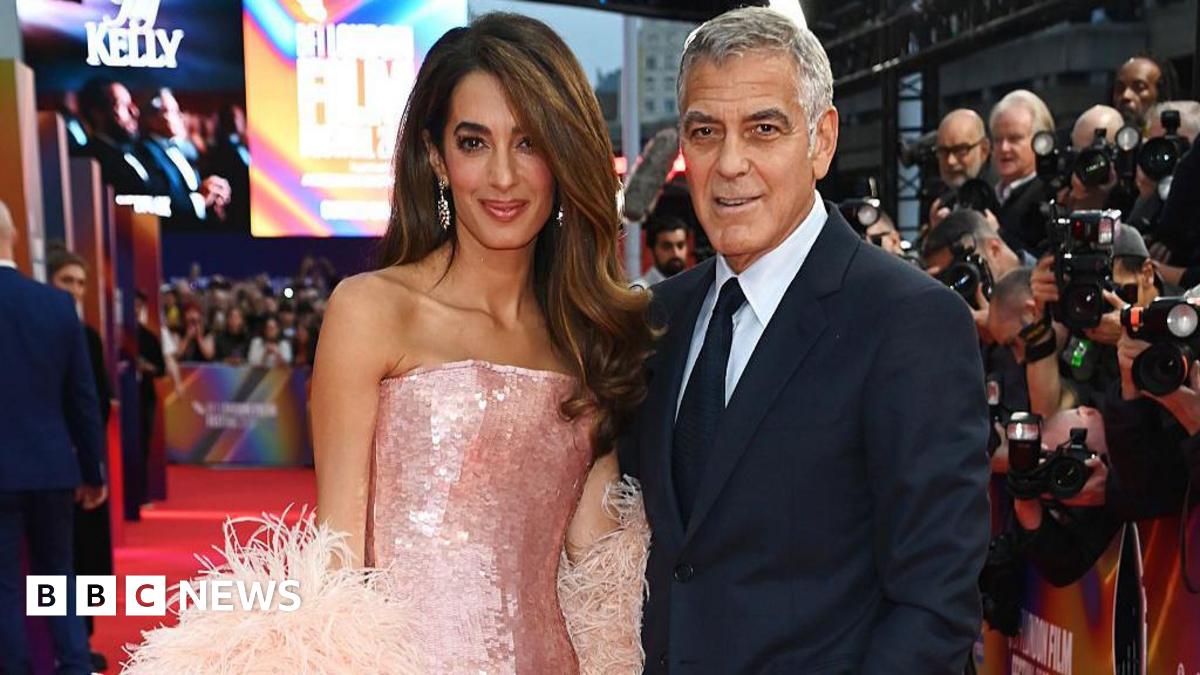 George and Amal Clooney on the red carpet at a movie premiere
