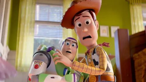 Pixar Toy Story toy Buzz Lightyear and Woody in a bedroom in a scene from the film