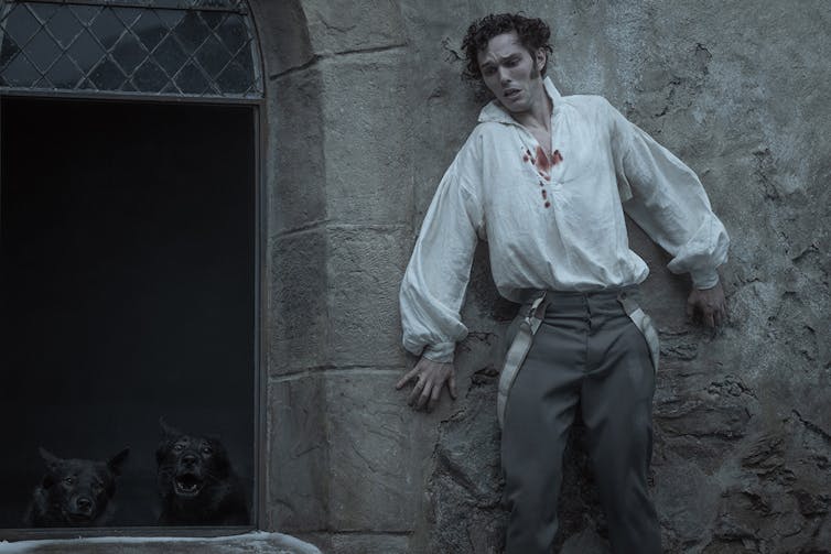 Still from Nosferatu movie, man hides from wolves