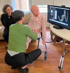 Occupational therapist Ruth Alecock uses the training robot 'Mona'
