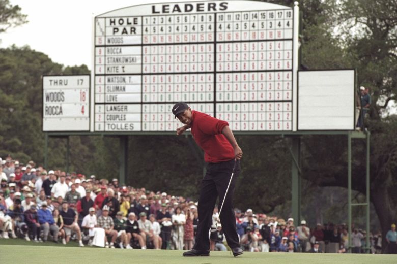 Woods sinks a putt to finish his dominant performance at the 1997 Masters.