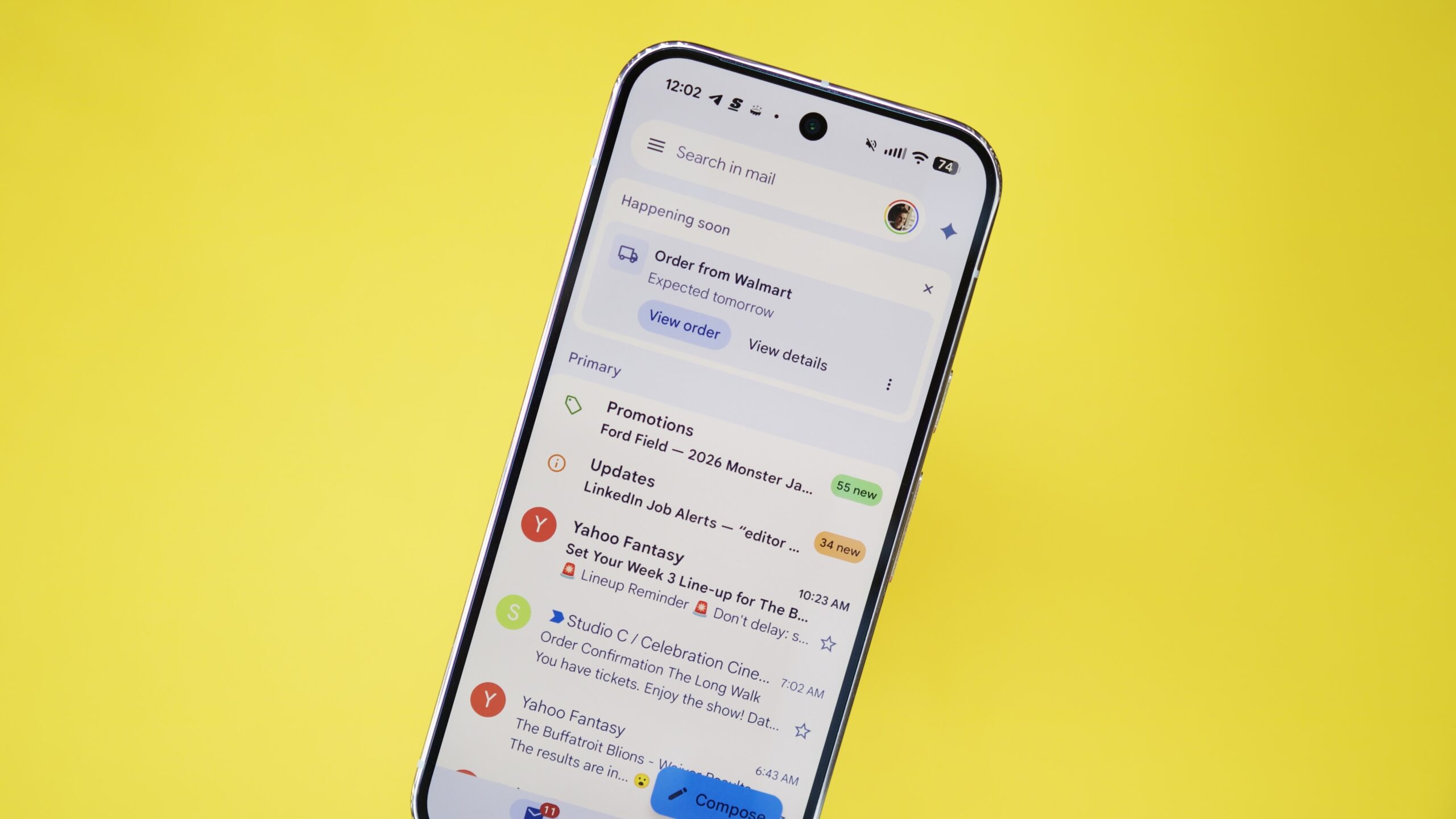 The Gmail app running on a Pixel phone, with a yellow background behind it.