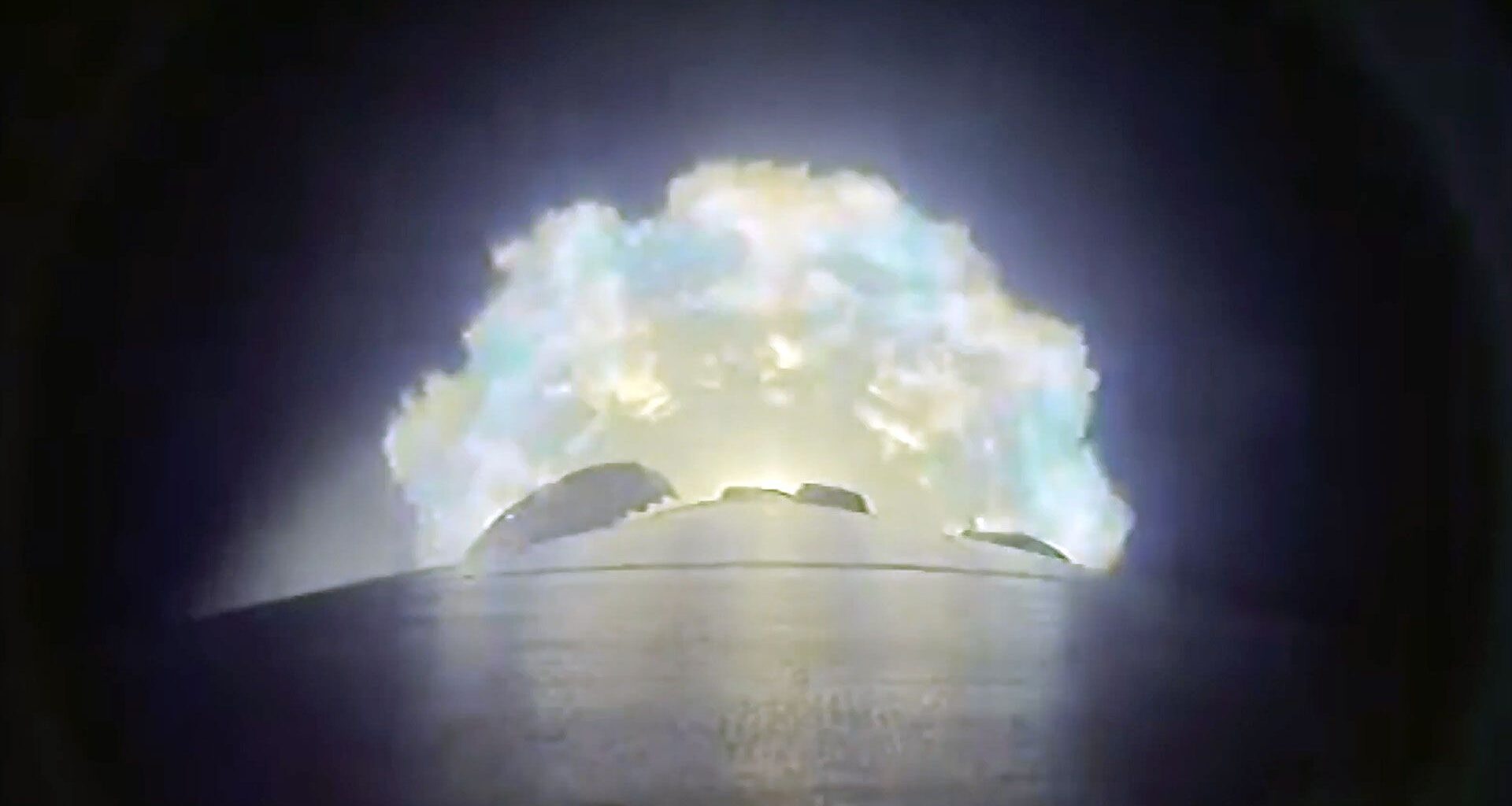 a camera mounted on the side of a rocket captures the plume from the booster's nine engines as they near cutoff and separation.
