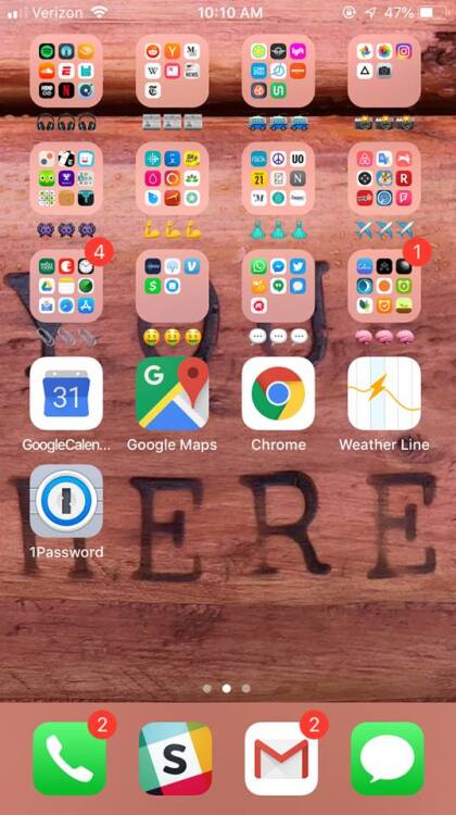 iPhone apps organized in folders labeled with emojis.