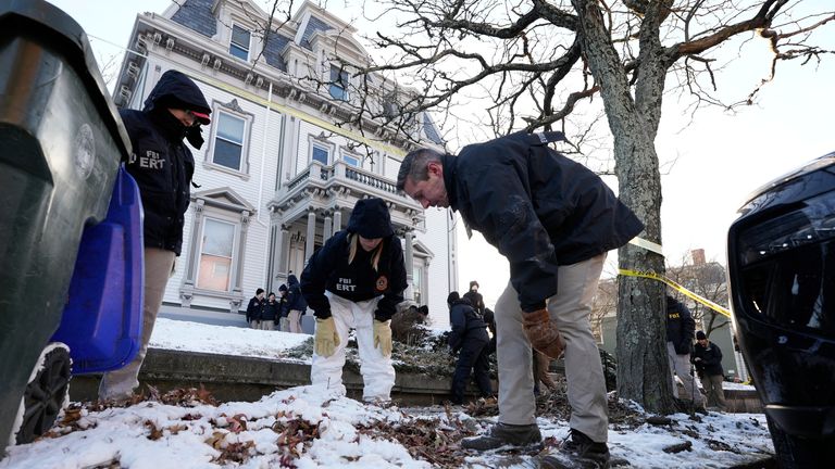 Members of the FBI search for evidence near the campus. Pic: AP
