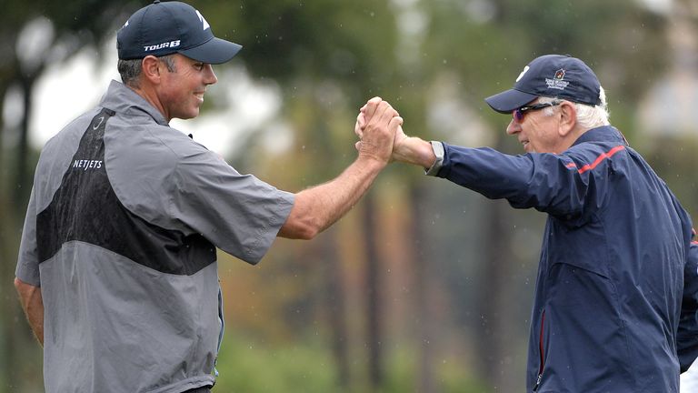 Matt Kuchar congratulates his father, Peter Kuchar, after making a putt during the first round of the Father Son tournament
