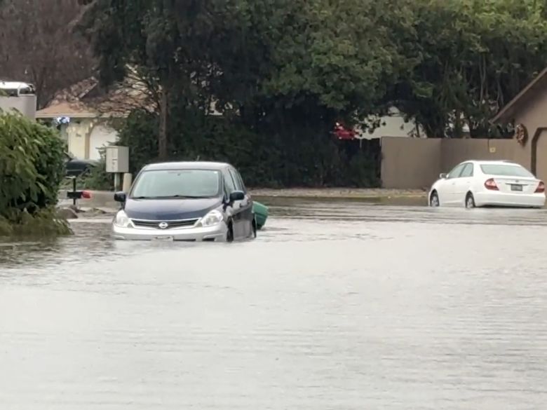 A car sits in floodwater in Redding, California, on Sunday.