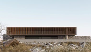 stone house by SHOVK perches over oceanfront slope in portugal