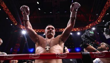 Oleksandr Usyk raises his arms in the ring after stopping Daniel Dubois in the fifth round at Wembley Stadium in London.