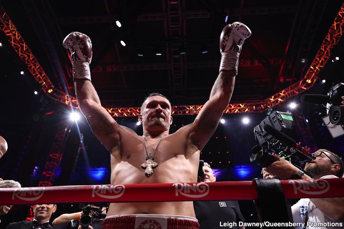 Oleksandr Usyk raises his arms in the ring after stopping Daniel Dubois in the fifth round at Wembley Stadium in London.
