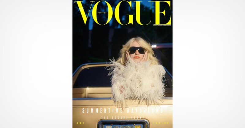 A person wearing black sunglasses and a white, feathered outfit stands in front of a gold car. The image is the cover of Vogue Portugal magazine, with large yellow text at the top and additional headlines below.