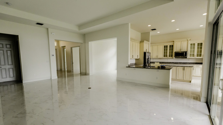 A newly constructed home with a large open plan kitchen and empty living room