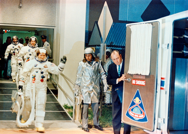 The crew of NASA's Apollo 8 mission, commander Frank Borman (right, waving), common module pilot Jim Lovell and lunar module pilot William Anders walk out to the transfer van on the way to the launch pad on Dec. 21, 1968.