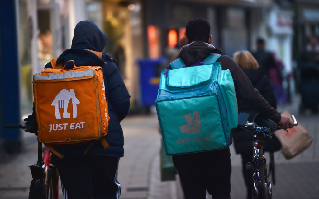 Just Eat and Deliveroo employees deliver food in York, England.