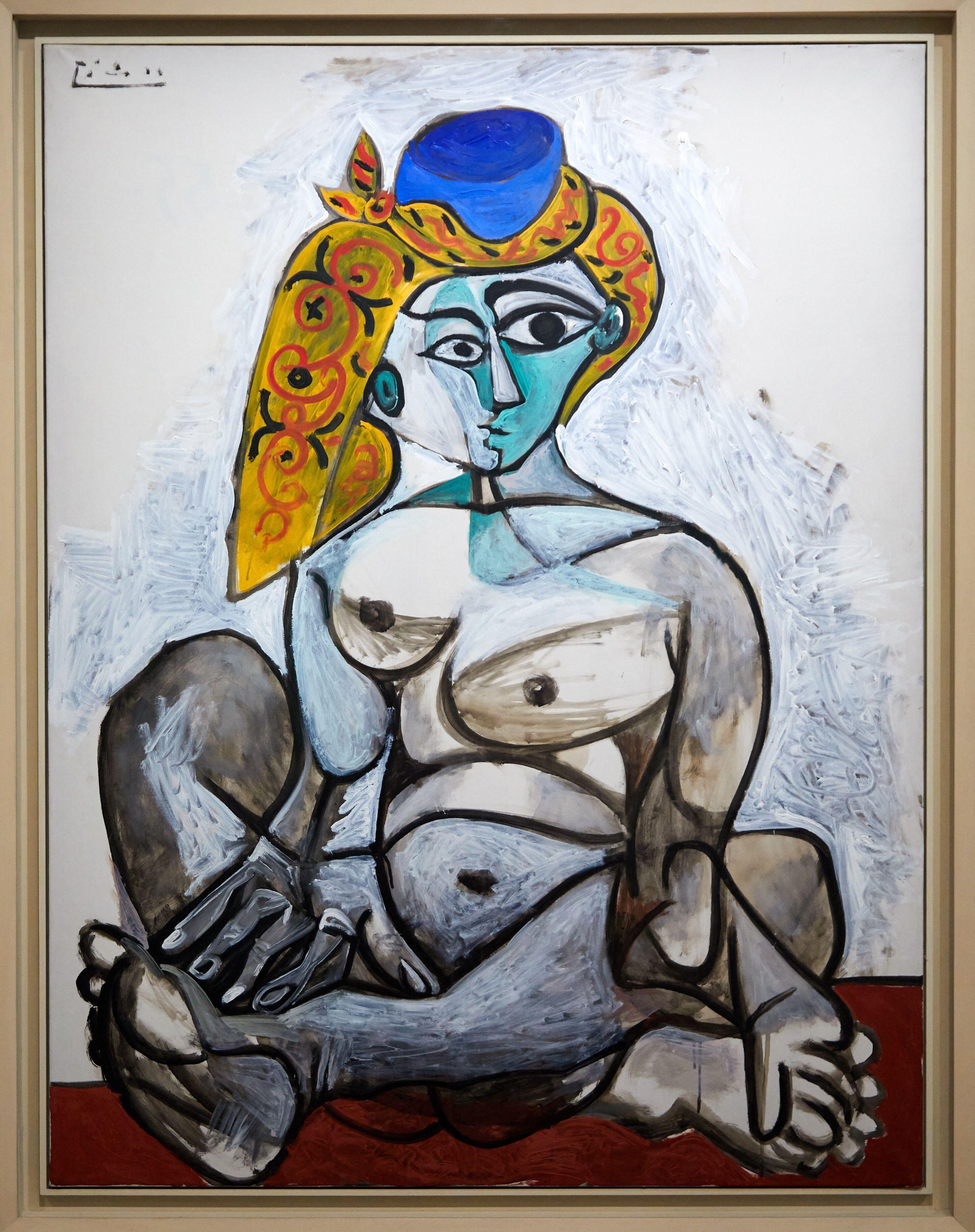 Illustration of Picasso's painting "Femme nue au bonnet turc" (Nude Woman in a Turkish Hat) from 1955, depicting a seated nude woman with stylized features, a blue hat, and yellow patterned hair, signed by Picasso in the upper left.