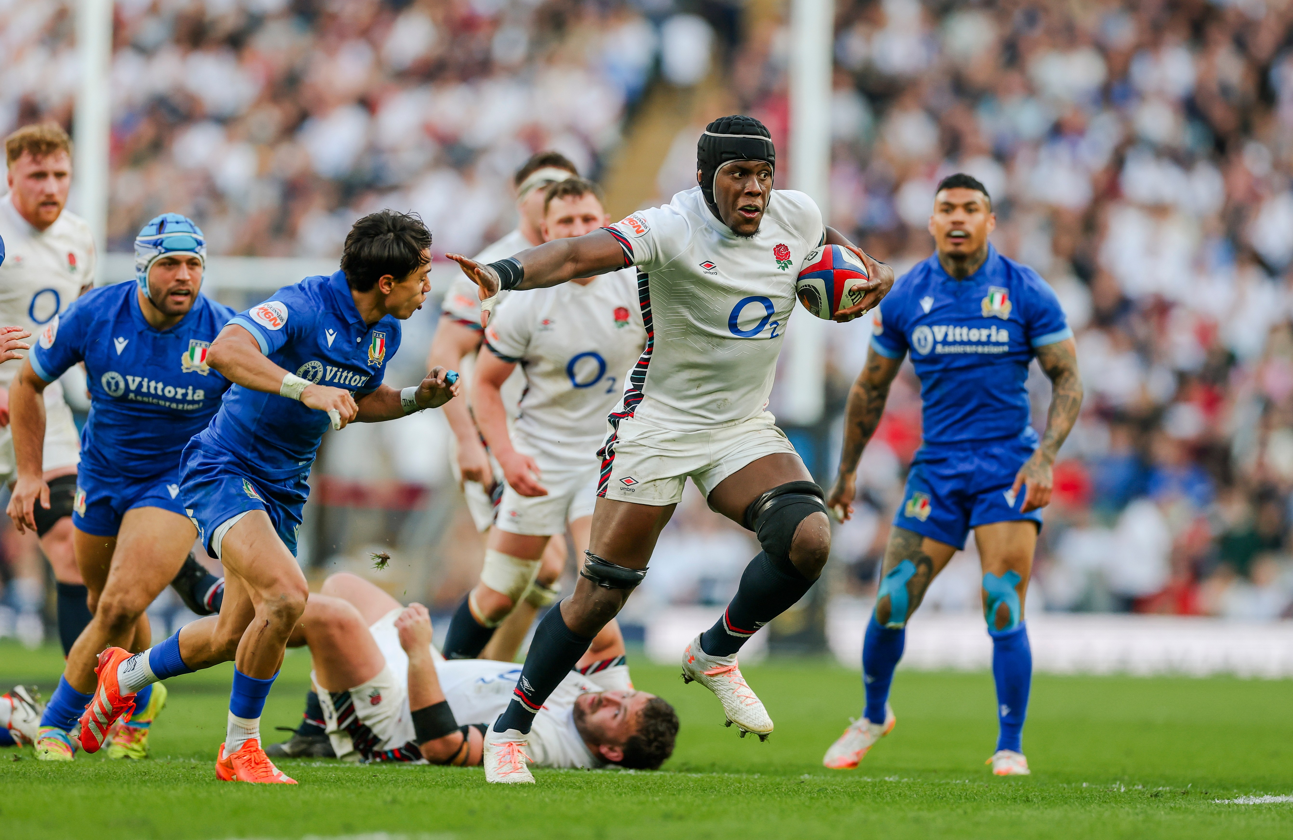 Maro Itoje, captain of England, runs with the rugby ball during a match against Italy at Twickenham Stadium.