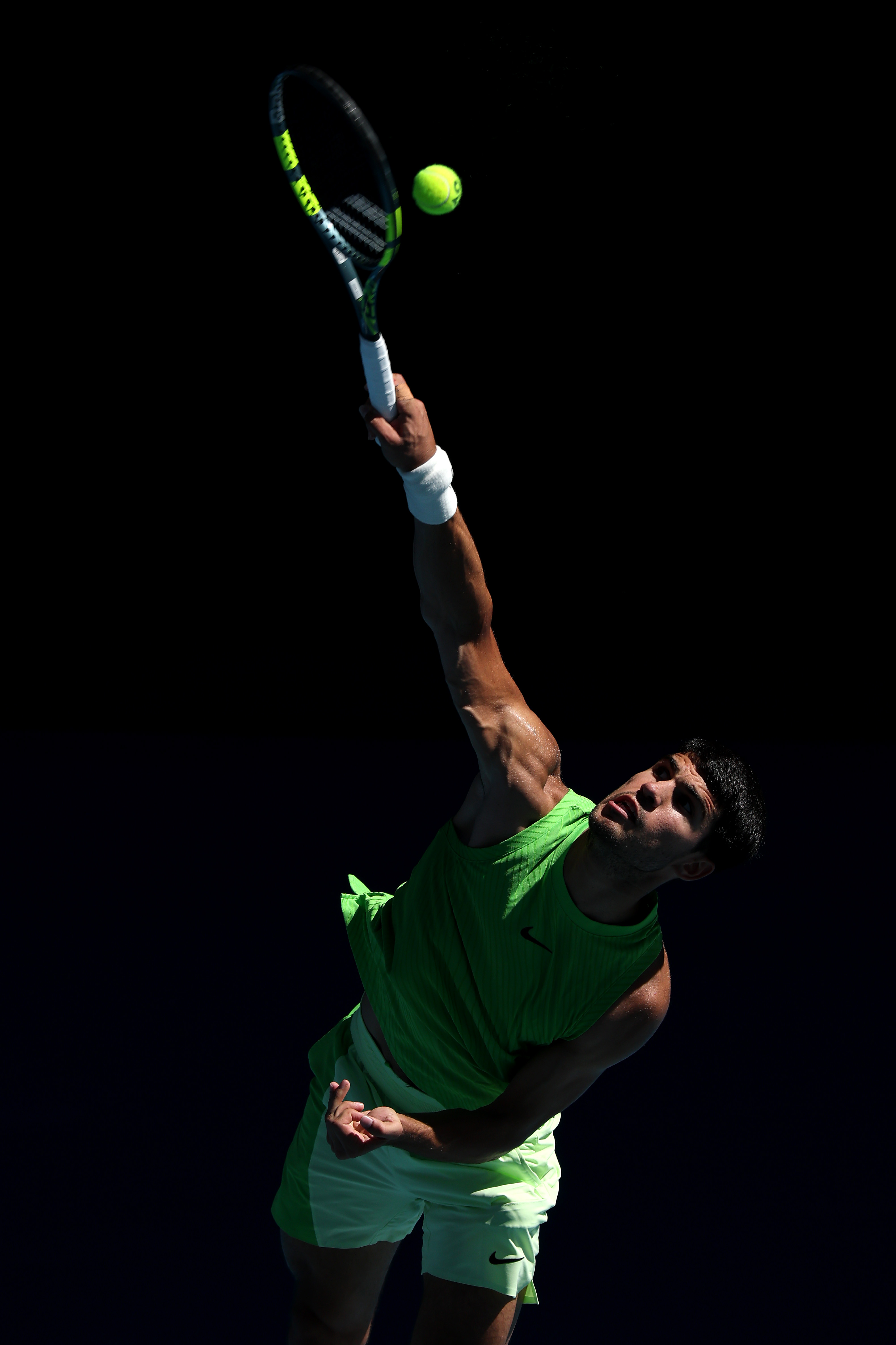 Carlos Alcaraz serving the ball at the 2026 Australian Open.
