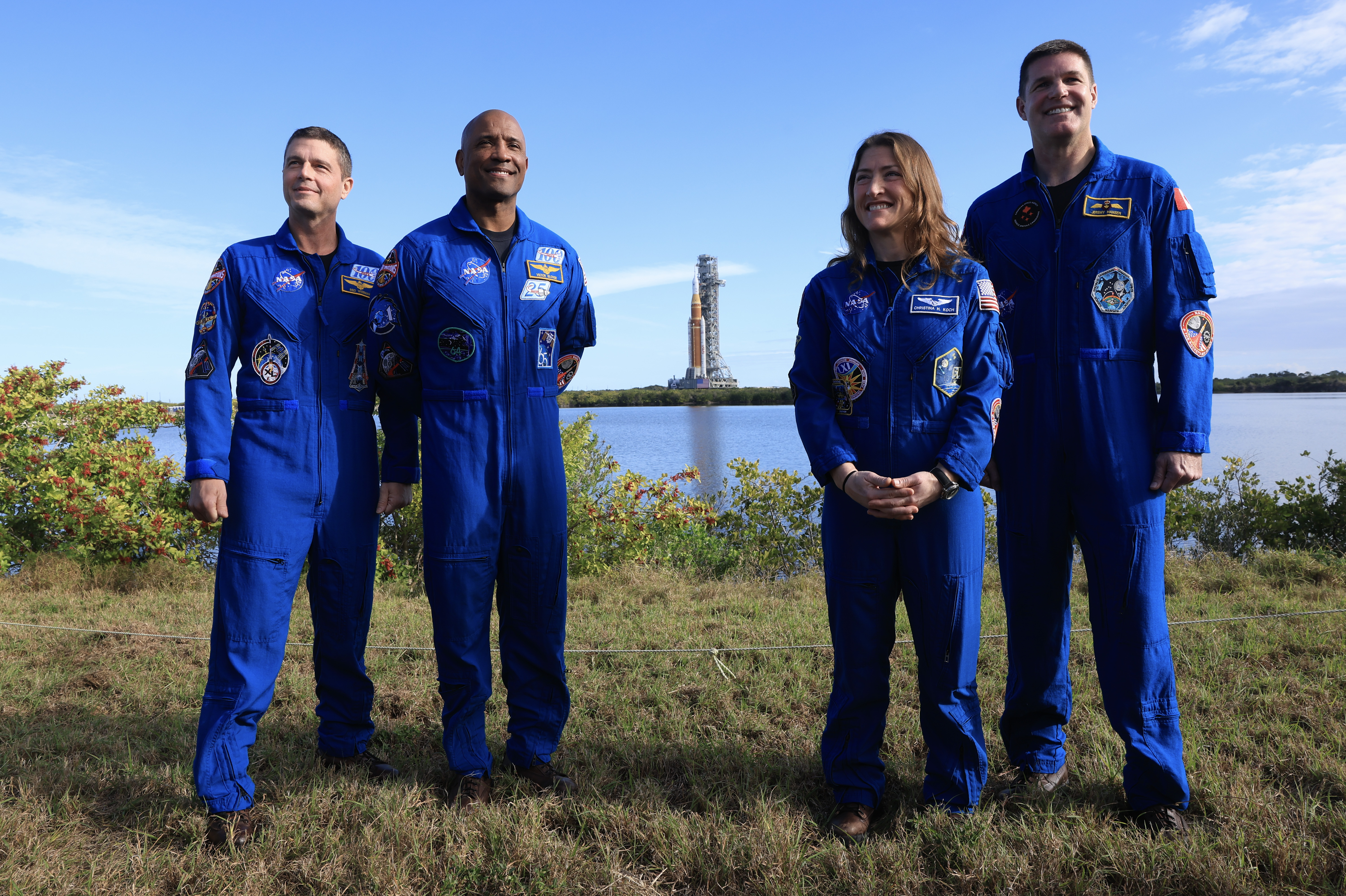 NASA's Artemis II crew poses with the SLS rocket and Orion spacecraft on Launch Pad 39B.