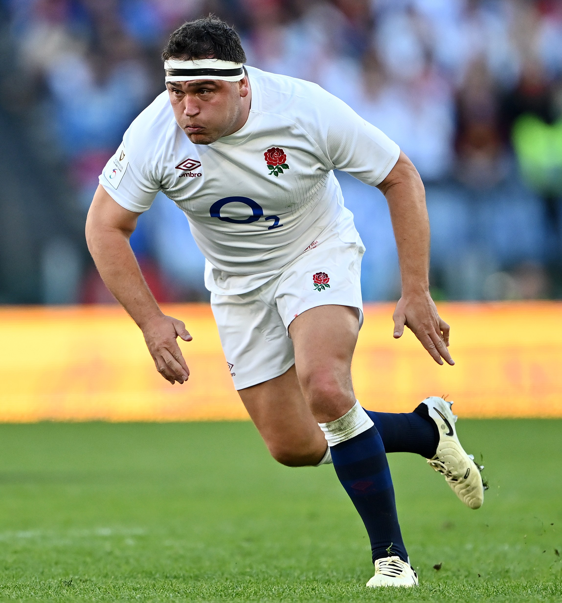 Jamie George of England in a defensive stance during a rugby match.