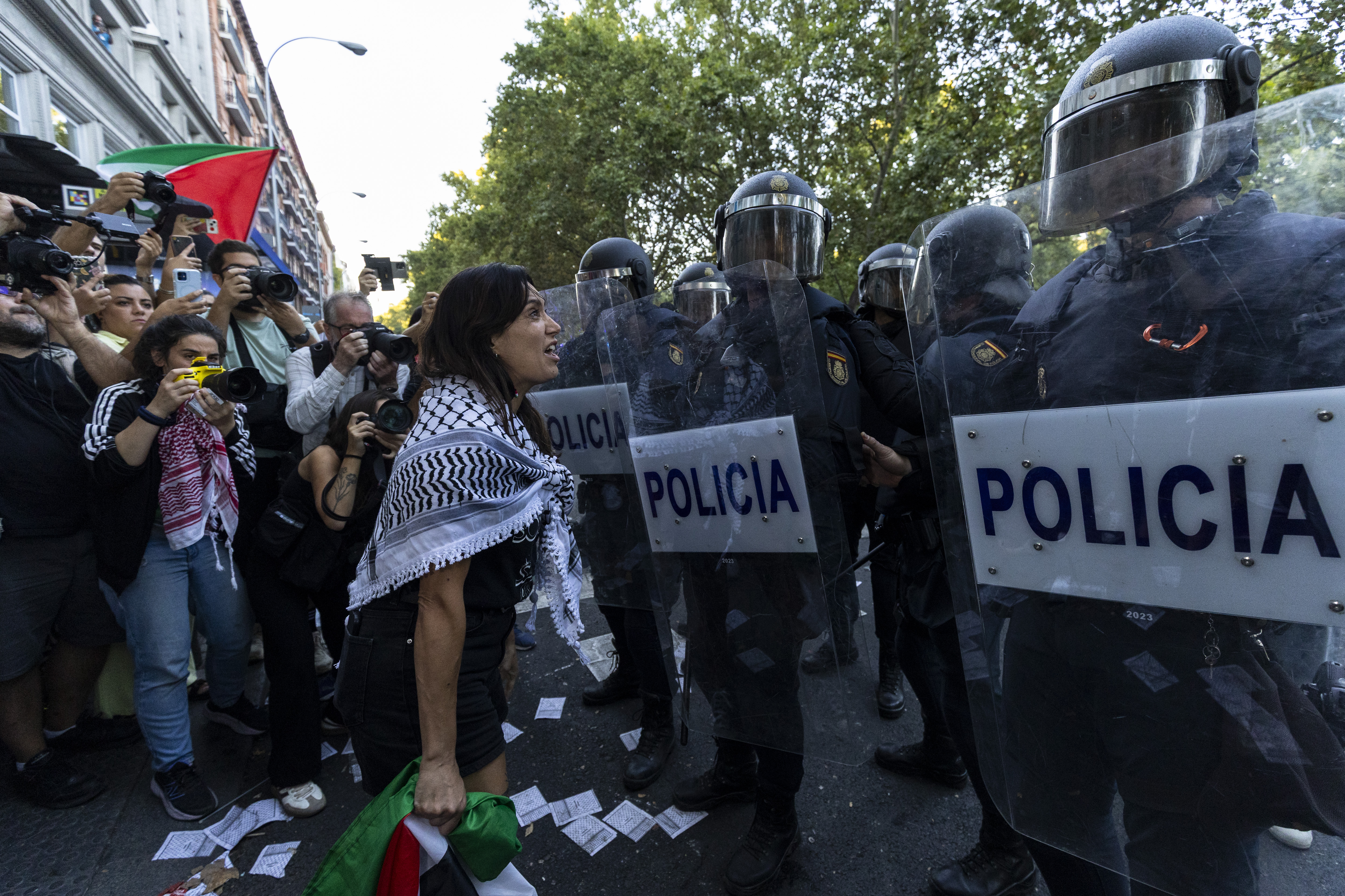A Pro-Palestinian protester speaking to police at the Vuelta race.