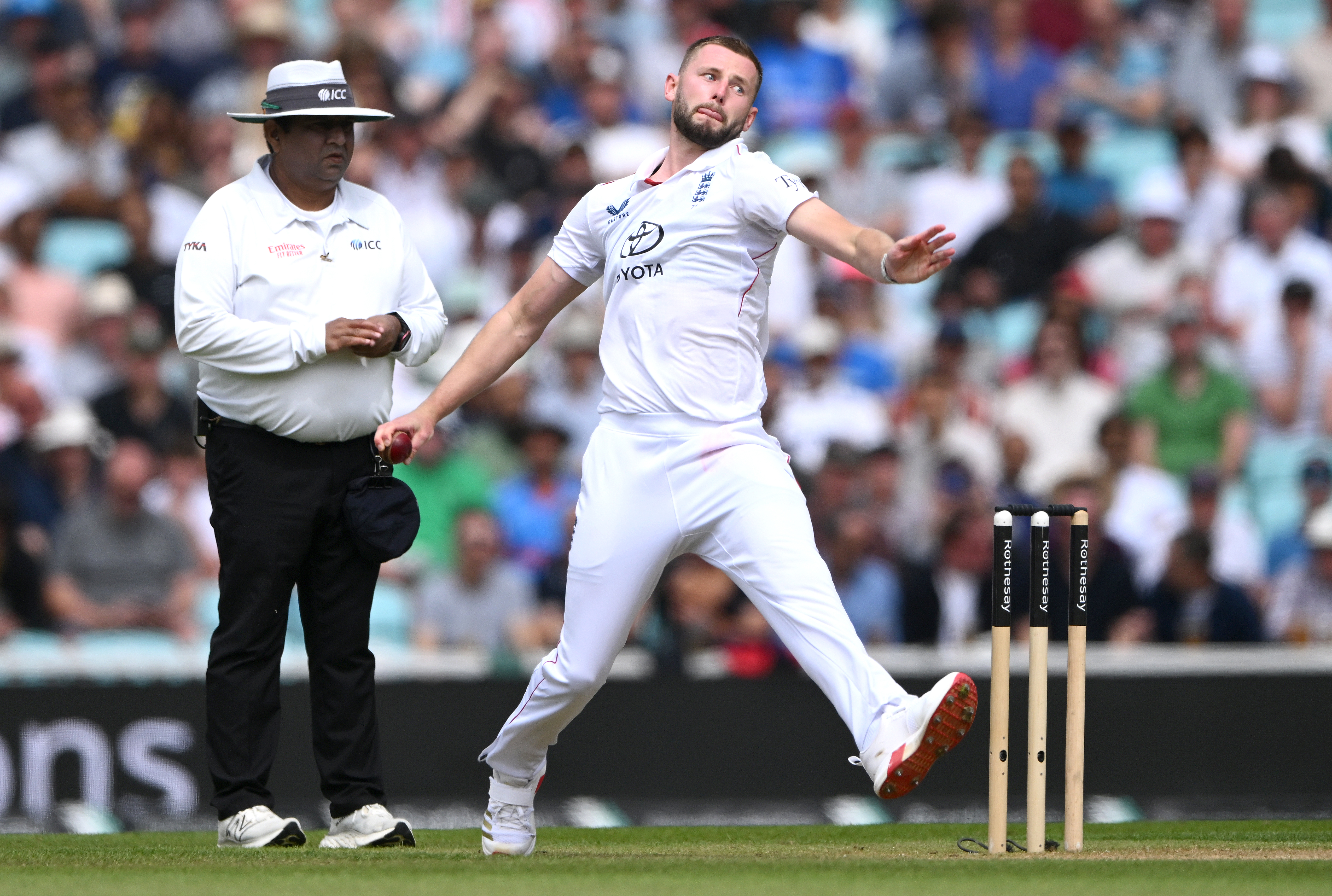 England bowler Gus Atkinson in bowling action during a cricket match.