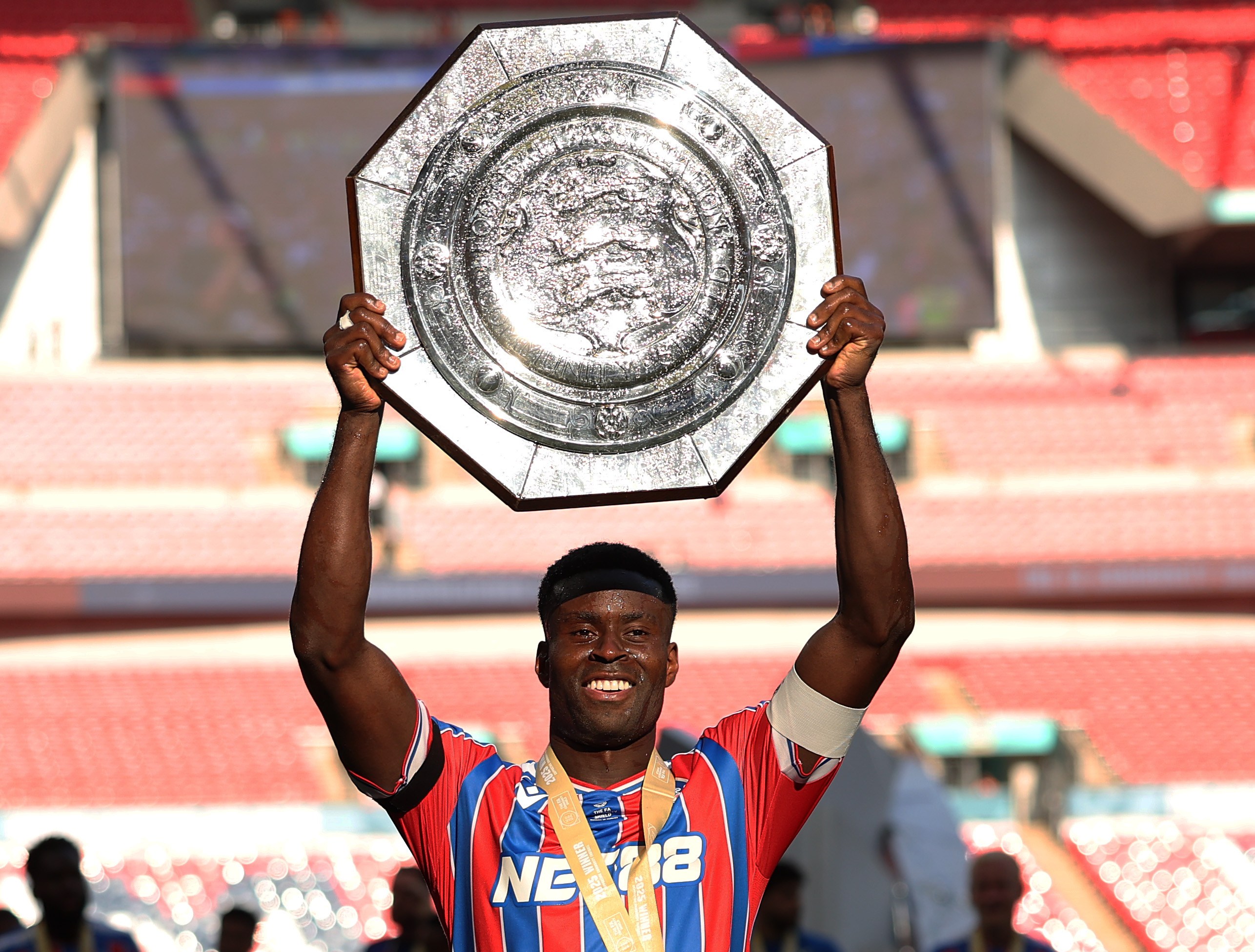 Marc Guehi holding the Charity Shield after Crystal Palace's win in the 2025 FA Community Shield.