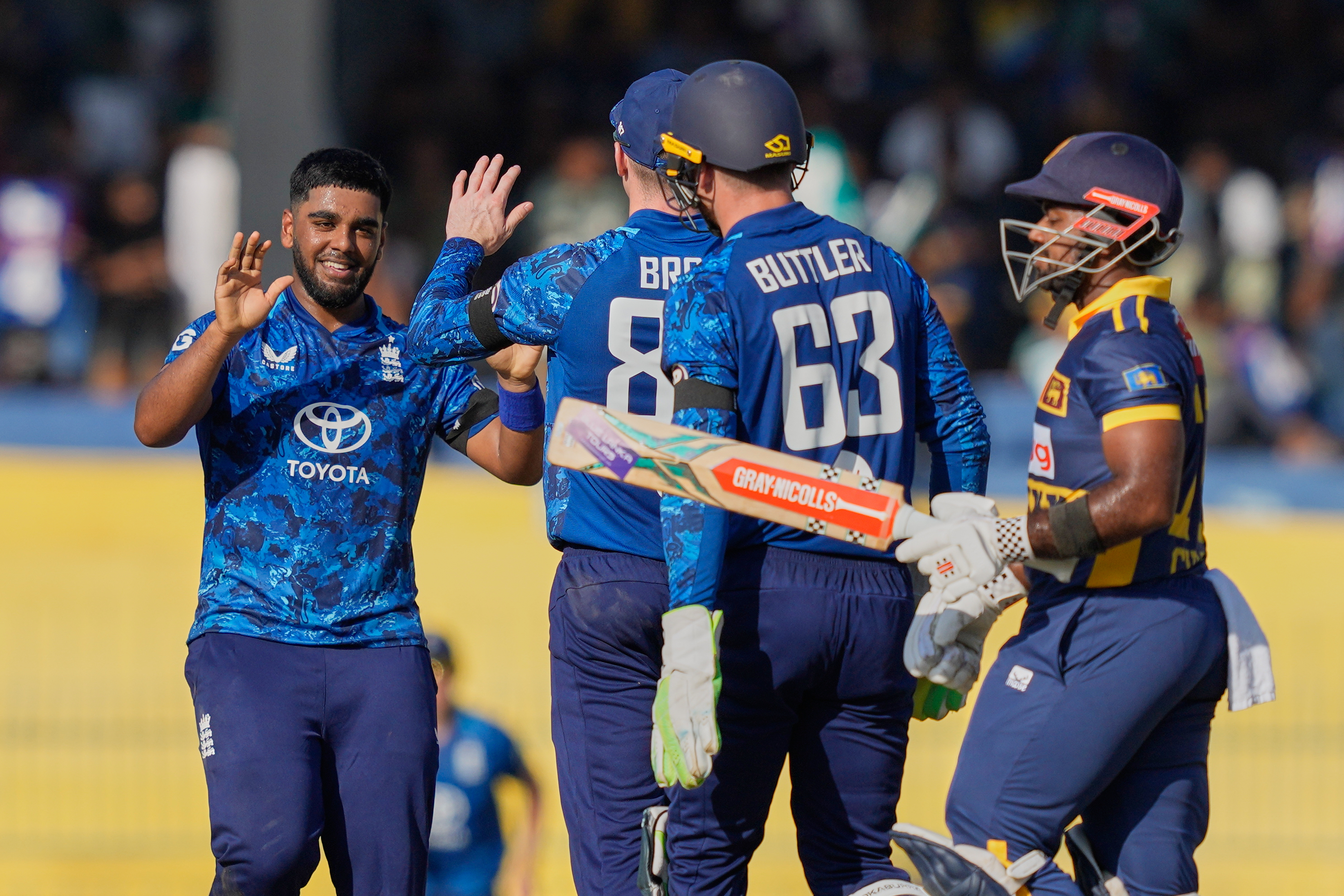 England's Rehan Ahmed celebrates with teammates the wicket of Sri Lanka's captain Charith Asalanka during an ODI cricket match.