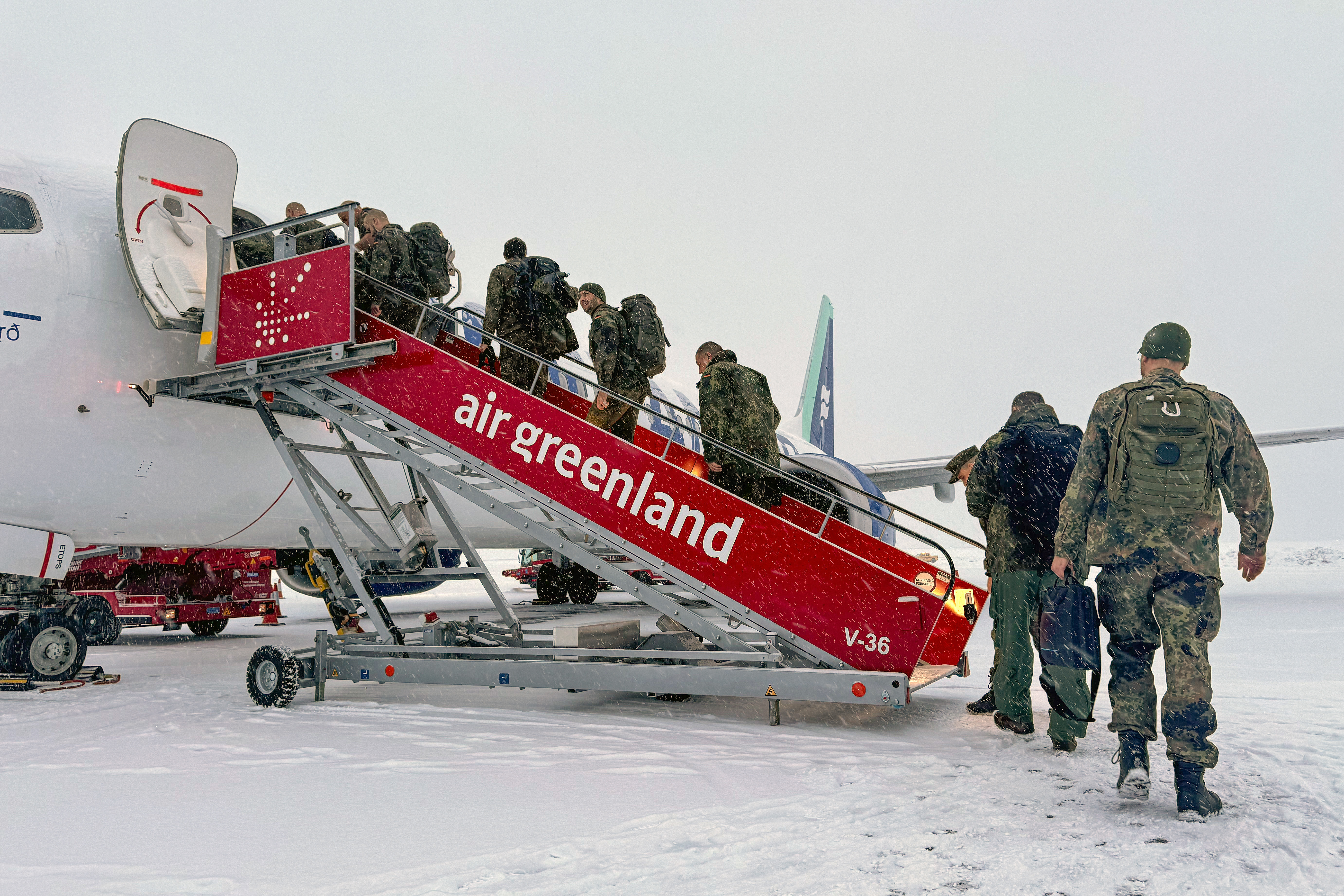 Personnel from the German armed forces board a flight leaving Nuuk airport for Reykjavik