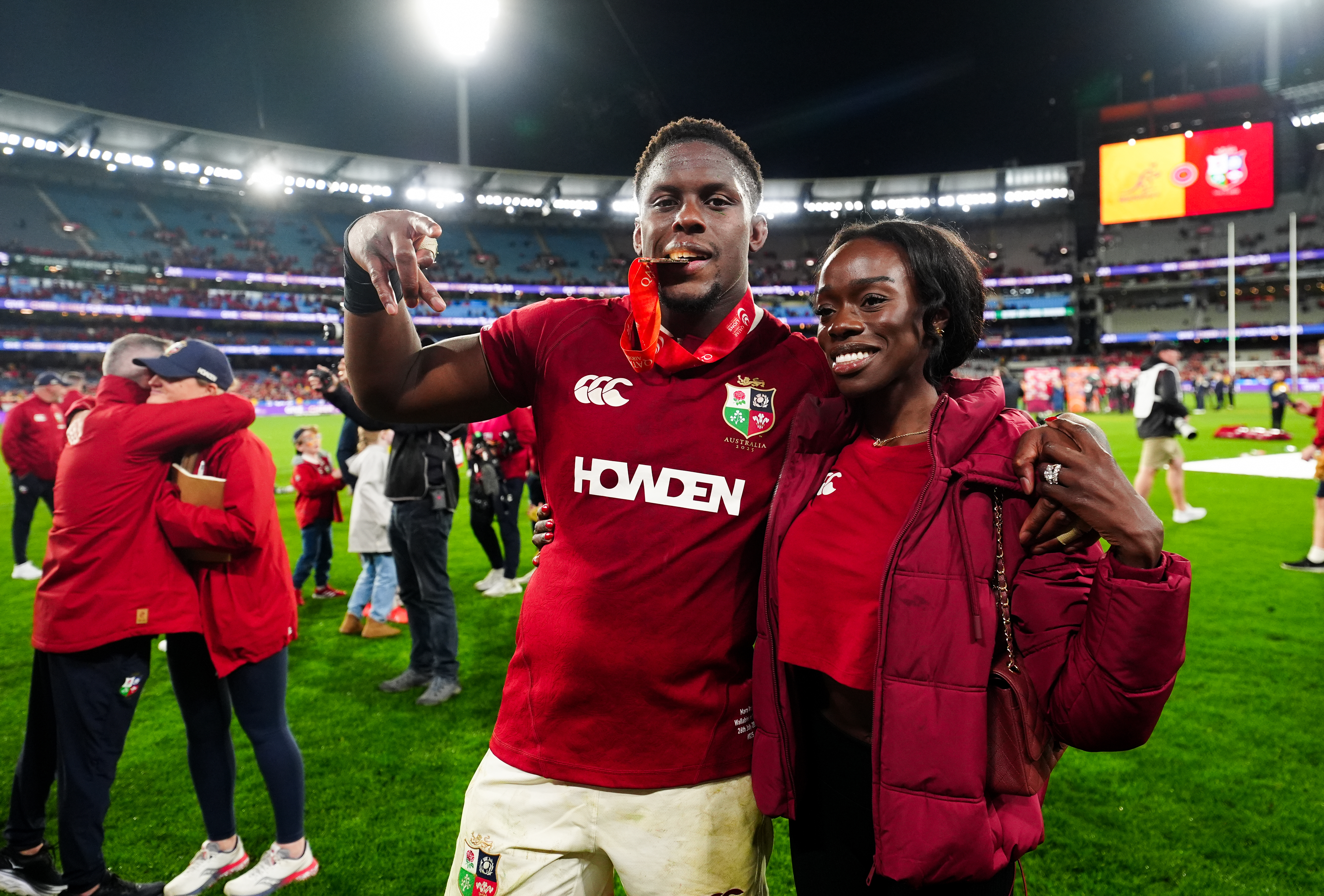 Maro Itoje of the British and Irish Lions and his wife Mimi celebrating a series victory at the Melbourne Cricket Ground.