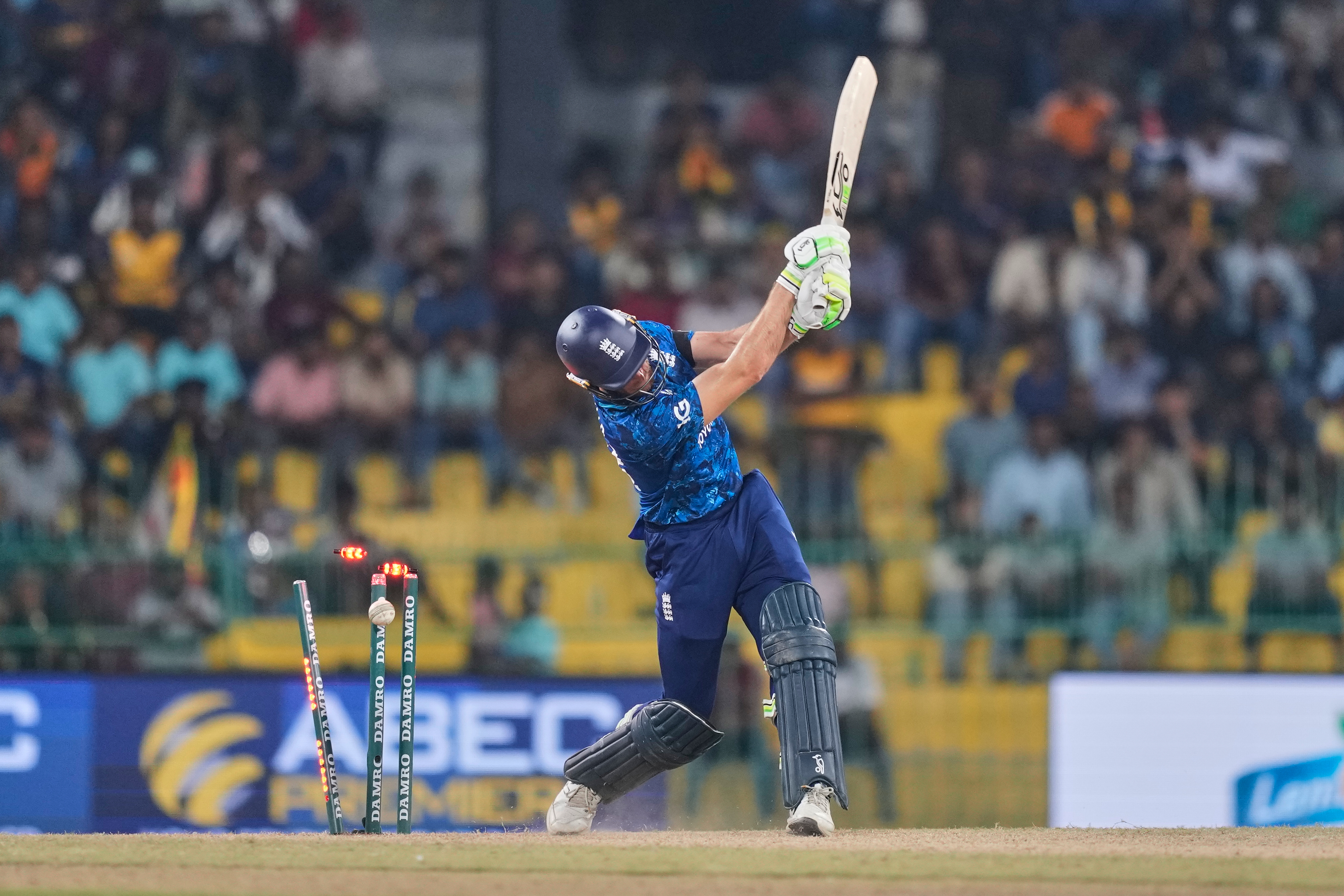 England's Jos Buttler is bowled by Sri Lanka's Pramod Madushan during an ODI cricket match.