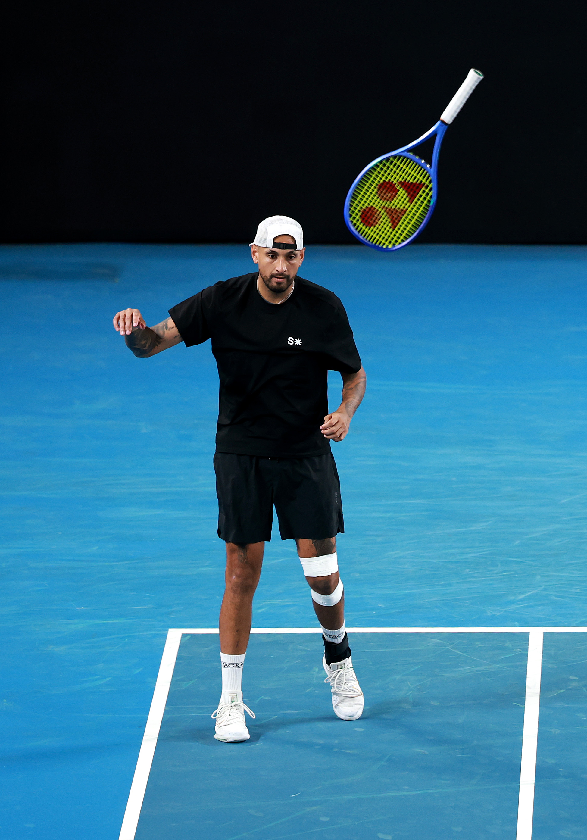 Nick Kyrgios reacting after throwing his racket.