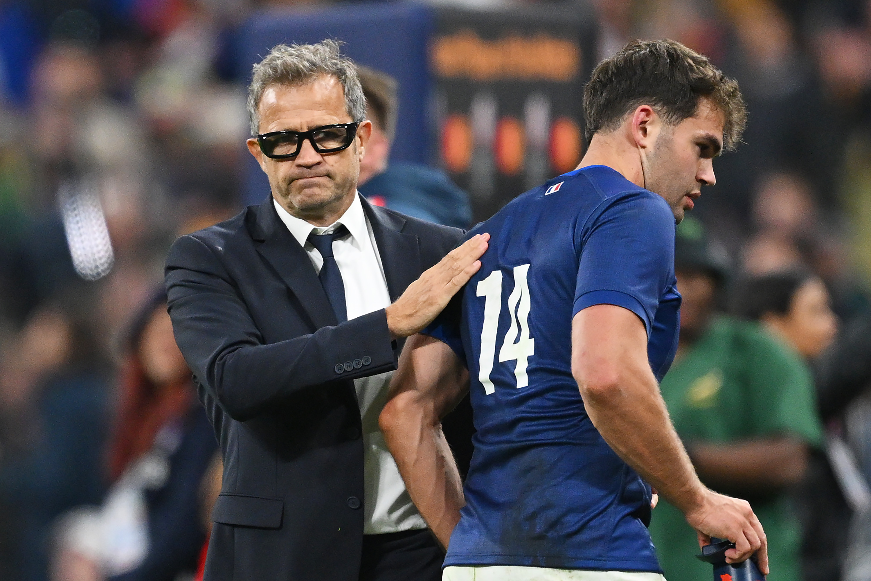 Fabien Galthie, Head Coach of France, consoles Damian Penaud of France after their loss in the Rugby World Cup Quarter Final match.