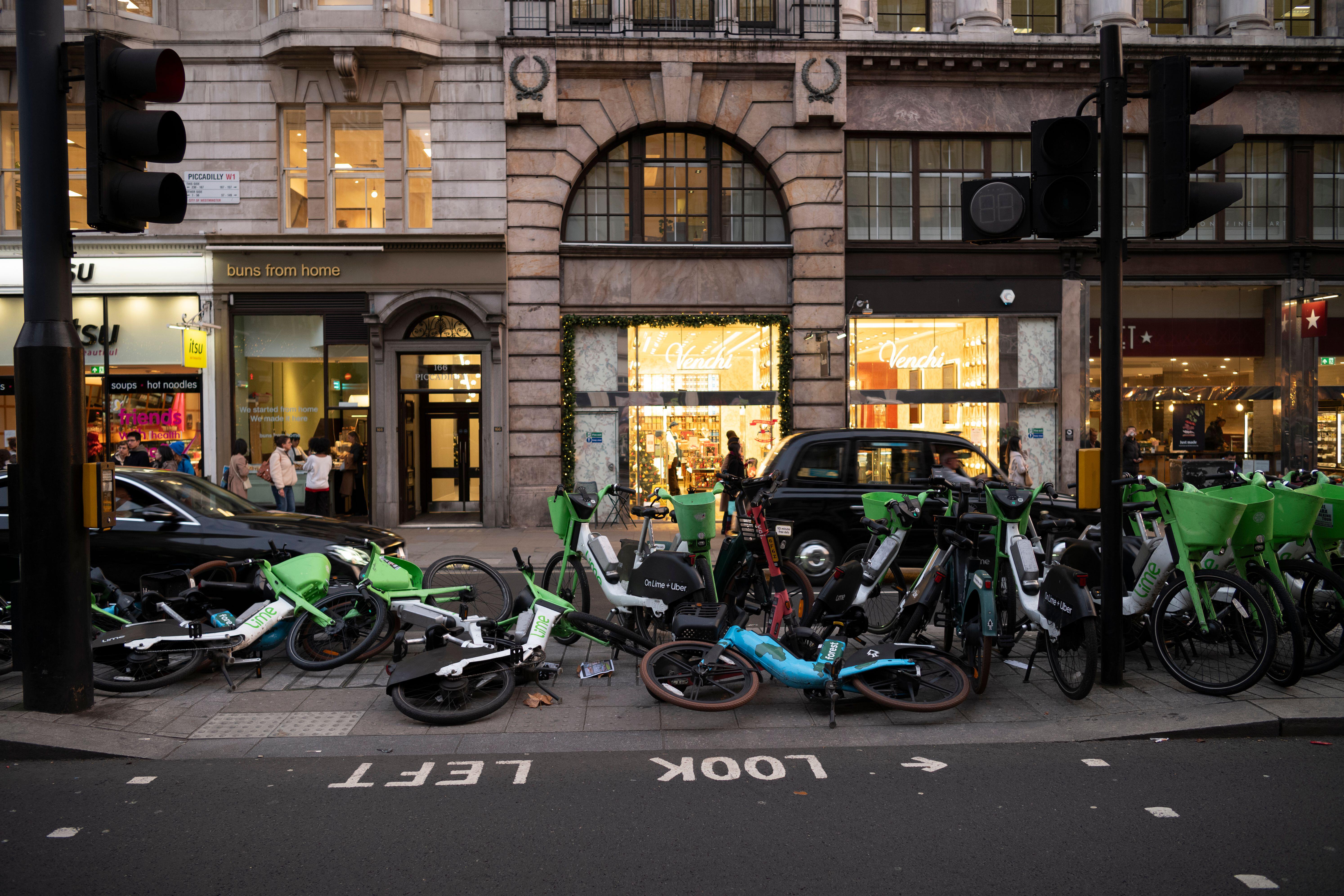 Lime e-bikes blocking the pavement along Piccadilly in London's Mayfair district.