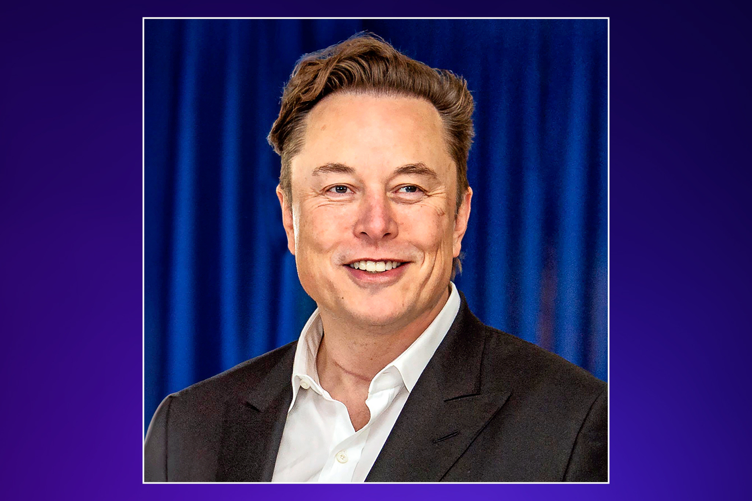 A headshot of Elon Musk smiling.