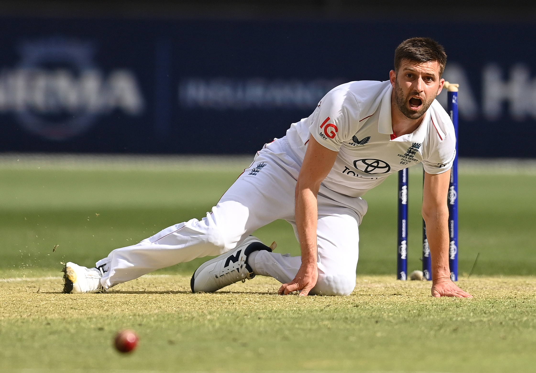 Mark Wood of England falls over after bowling during day two of the First 2025/26 Ashes Series Test Match.