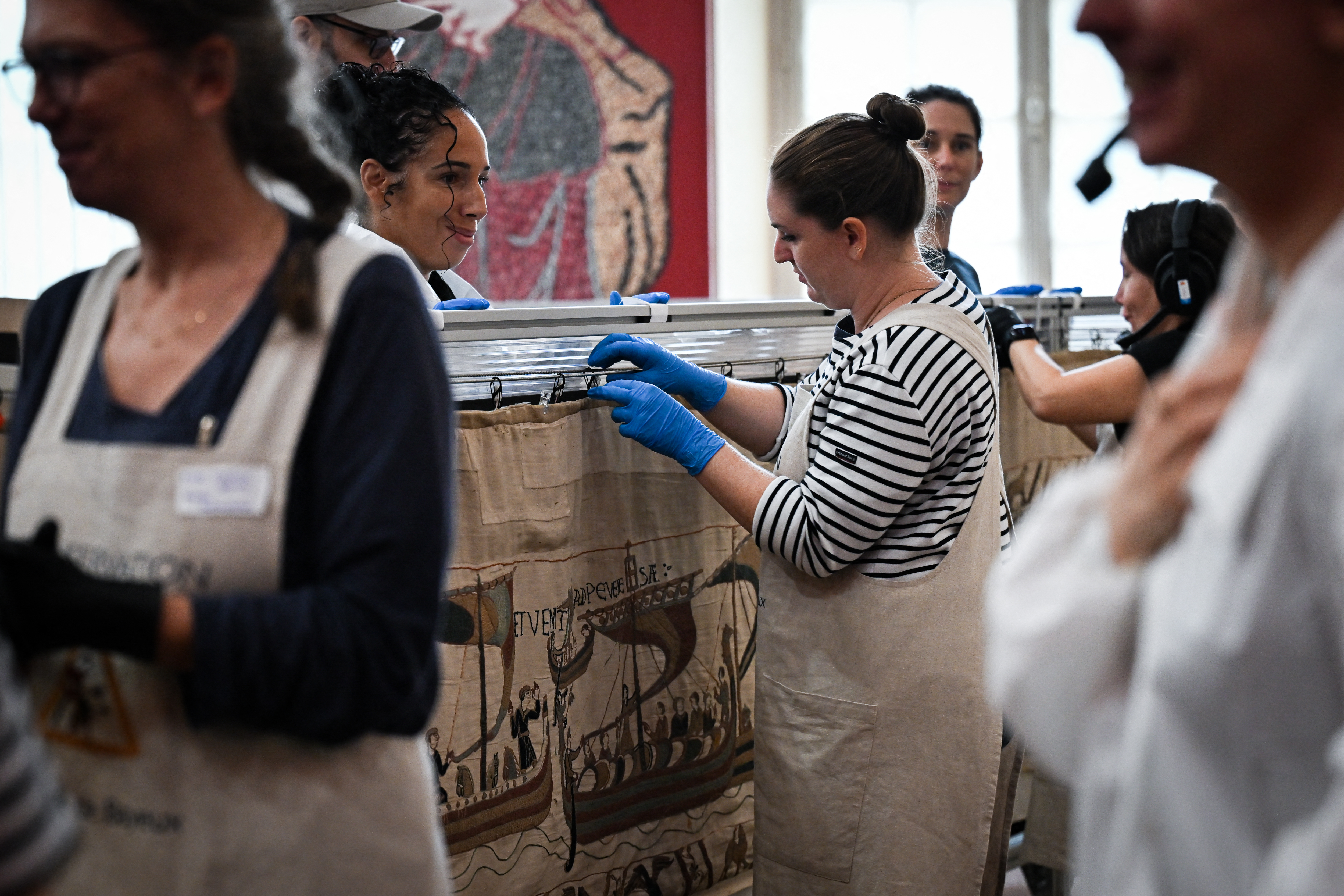 Workers and volunteers prepare the Bayeux Tapestry for packing.