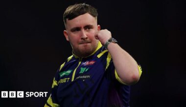 Luke Littler holds up his fist to celebrate