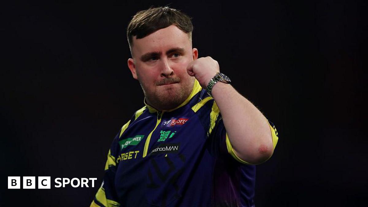 Luke Littler holds up his fist to celebrate