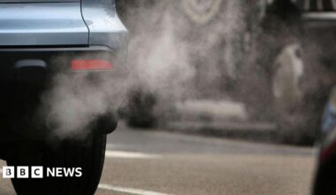 A car pouring fumes out of its exhaust