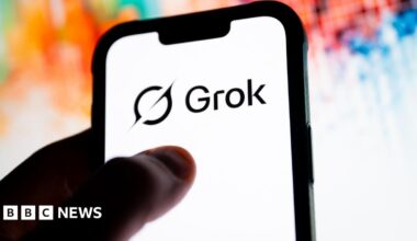A phone with the Grok logo on it and a colourful background