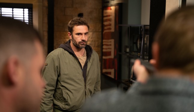 John Sugden standing in Mill Cottage flat with Aaron and Robert in Emmerdale
